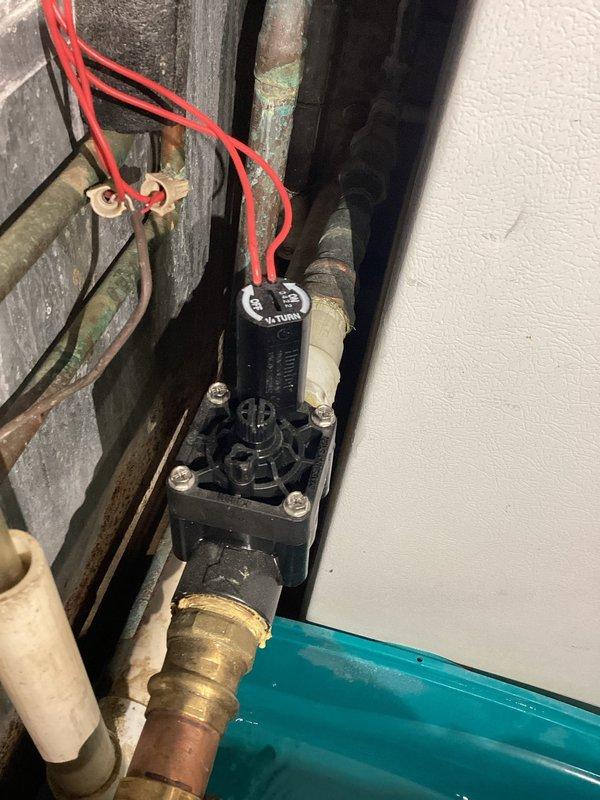 Responded to recurring leak in geothermal zone valve that has required replacement twice in the past two years. Diagnosed active water leak at zone valve assembly and documented condition with photos showing corroded brass fittings and aged copper piping connections. Presented customer with repair options including replacement with standard plastic zone valve requiring periodic replacement every few years versus upgraded brass valve with potential noise concerns and no guaranteed improvement in longevity. Recommended maintaining current plastic valve specification and keeping spare unit on-site for future replacement due to straightforward installation process when proper valve is available.