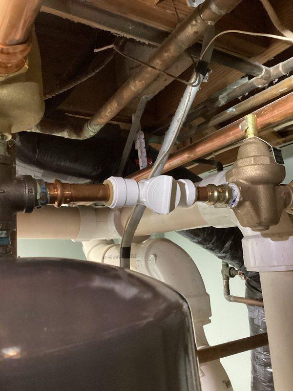 Responded to no heat and no hot water complaint on residential boiler system installed in 2020. Upon arrival, found boiler not firing and multiple water leaks present in the system. Diagnosed leaking shut-off valve on auto-fill system; isolated valve to stop active leak. Identified leaking ball valve at circulator pump, tightened compression nut to eliminate leak. Auto-fill system found to be non-functional, preventing proper system pressurization. Manually added water to boiler to restore proper operating pressure. Successfully started system and verified boiler ignition and proper operation of all components. Located additional leak at fitting above water heater requiring specialized part not currently in stock. System restored to full operation with temporary repairs holding. Provided estimates for permanent repairs including replacement of auto-fill shut-off valve and auto-fill assembly to prevent recurrence. Parts order submitted for water heater fitting repair. System operational