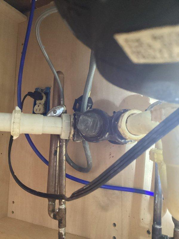 Responded to kitchen sink drain leak caused by corroded cast iron pipe with visible hole in the line. Removed deteriorated cast iron piping from under kitchen sink and installed new PVC drain line connecting to existing basement stack. Replaced compromised drain assembly with code-compliant materials, ensuring proper slope and secure connections throughout the drainage system.