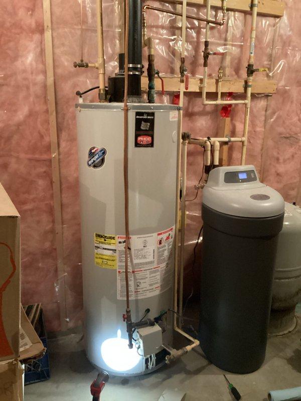 Responded to a no hot water complaint with low water pressure. Upon inspection, diagnosed a failed gas valve on the existing tanked water heater. Removed the old unit from the basement and installed a new 50-gallon natural gas water heater. Connected all copper supply lines, gas piping, and exhaust venting per manufacturer specifications. Installed shutoff valves and verified proper operation of the new unit. System tested and confirmed adequate hot water delivery and restored water pressure.