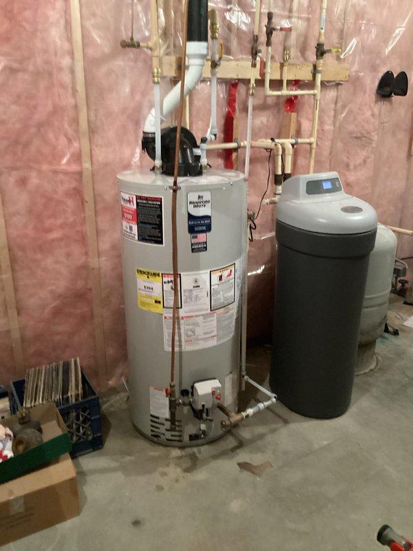 Responded to a no hot water complaint with low water pressure. Upon inspection, diagnosed a failed gas valve on the existing tanked water heater. Removed the old unit from the basement and installed a new 50-gallon natural gas water heater. Connected all copper supply lines, gas piping, and exhaust venting per manufacturer specifications. Installed shutoff valves and verified proper operation of the new unit. System tested and confirmed adequate hot water delivery and restored water pressure.