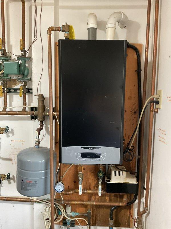 Responded to service call for HTP high-efficiency boiler requiring intermittent system resets when temperature was adjusted. Upon inspection, discovered loose TT wire connection on zone pump that was preventing boiler from responding to heat calls. Secured and properly terminated all loose wiring at zone pump to restore reliable electrical connection. Verified boiler operation with no error codes present and system responding properly to thermostat calls. Instructed customer to note any error codes displayed if issue recurs for further diagnostic reference.