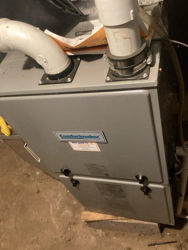 Responded to no heat call on Comfortmaker furnace system. Upon arrival, found unit cycling on high limit safety. Discovered severely restricted airflow caused by heavily soiled air filter and nearly completely blocked secondary heat exchanger. Removed and replaced dirty filter, then removed blower assembly to access and thoroughly clean secondary heat exchanger. After cleaning, tested system operation and confirmed proper heating cycle with no limit trips and correct blower operation. Educated occupant on importance of regular filter maintenance to prevent future heat exchanger blockage, particularly with pets in home.