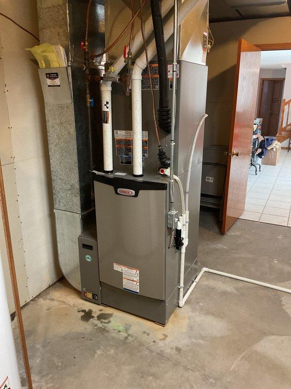 Responded to callback regarding smoke detectors activating and haze in home following new Lennox furnace installation. Confirmed odor and haze were normal burn-off from new equipment and dissipated after initial runtime. Addressed low airflow complaints on main and upper levels by adjusting airflow settings on S40 zoning system for both zones, optimizing performance for the large, spread-out floor plan requiring maximum airflow capacity.