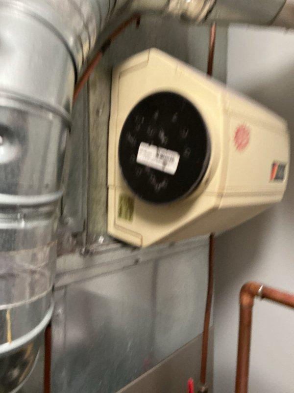 Responded to customer complaint of unusual odor emanating from 22-year-old Bryant HVAC system and spreading into living spaces. Performed comprehensive inspection of heating system including heat exchanger examination and venting components to identify source of smell. Discovered plastic bag partially melted on water heater in mechanical room, which was the cause of the odor. Removed debris, verified MERV 14 filter condition, and confirmed system operation was normal with no safety concerns.