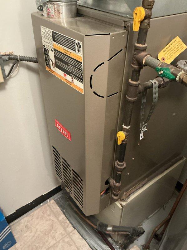 Responded to customer complaint of unusual odor emanating from 22-year-old Bryant HVAC system and spreading into living spaces. Performed comprehensive inspection of heating system including heat exchanger examination and venting components to identify source of smell. Discovered plastic bag partially melted on water heater in mechanical room, which was the cause of the odor. Removed debris, verified MERV 14 filter condition, and confirmed system operation was normal with no safety concerns.