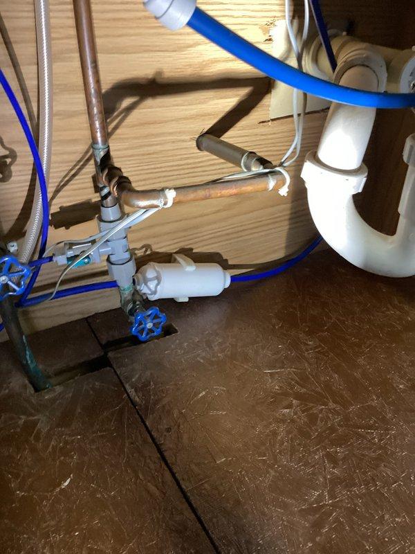 Replaced exterior hose bibb that was plumbed through crawl space, installing new frost-free spigot in recessed wall box with proper mounting to exterior siding. Rebuilt second hose bibb located at kitchen side of home, replacing worn valve assembly and ensuring proper shutoff function. Replaced hose bibb under kitchen sink, integrating new valve with existing water filtration system and supply lines while maintaining proper connections to copper supply pipes and PVC drain assembly.