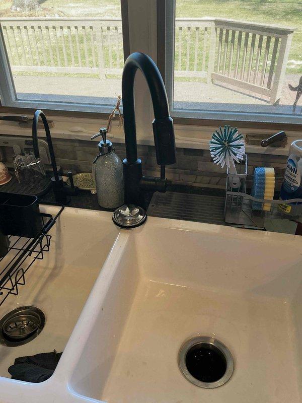 Responded to a return service call for a leak underneath the kitchen sink originating from the garbage disposal. Upon inspection, determined that the disposal unit had become dislodged from its mounting assembly, likely disturbed during previous day's piping replacement work to the stack. Removed the garbage disposal unit, properly reinstalled it to the mounting ring, and securely tightened all connections to manufacturer specifications. Verified proper seal and tested unit operation to confirm leak was fully resolved.