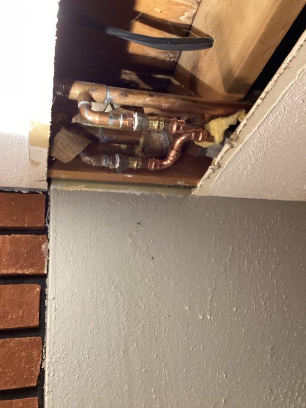 Responded to a water leak in the basement ceiling originating from the plumbing system serving an upstairs toilet. Upon inspection, identified a faulty mixing valve in the copper supply lines within the ceiling cavity as the source of the leak. Removed and eliminated the defective mixing valve, reconfigured the supply piping, and restored proper water flow to the toilet fixture. Verified all connections were secure and leak-free upon completion.