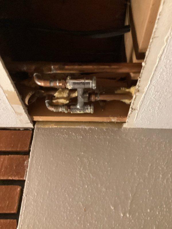 Responded to a water leak in the basement ceiling originating from the plumbing system serving an upstairs toilet. Upon inspection, identified a faulty mixing valve in the copper supply lines within the ceiling cavity as the source of the leak. Removed and eliminated the defective mixing valve, reconfigured the supply piping, and restored proper water flow to the toilet fixture. Verified all connections were secure and leak-free upon completion.