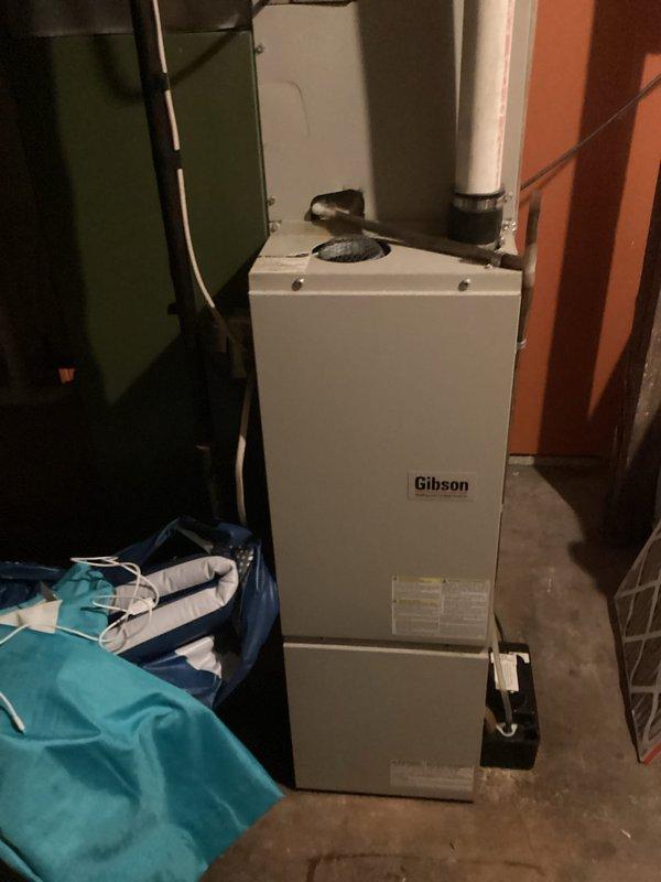 Responded to no heat call on 2-year-old Gibson furnace. Upon arrival, confirmed furnace was attempting to run but producing no heat. Diagnosed failed hot surface igniter - verified proper voltage output from control board during igniter call, but igniter measured open line (OL) on ohmmeter, confirming element failure. Gas valve was opening as designed but no ignition occurring due to failed igniter component.

During diagnostic process, observed blower motor exhibited labored startup indicating potential bearing wear or motor degradation. Conducted visual inspection of heat exchanger and documented areas of concern, though no active cracks or breaches were detected at time of inspection. Found air filter heavily restricted with debris, contributing to system stress.

Required igniter not available on service vehicle. Documented findings with photographs showing internal components and heat exchanger condition. Provided customer with complete assessment including failed igniter requirin