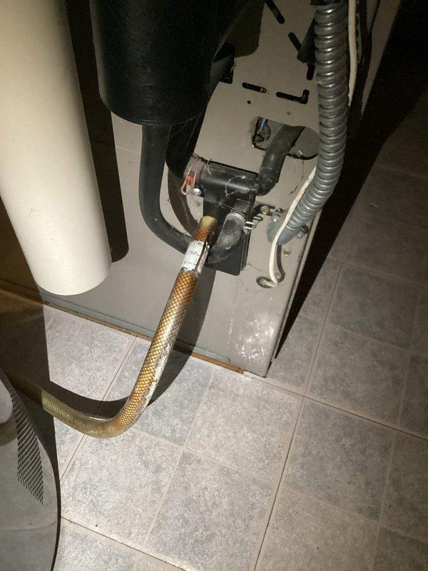 Responded to report of water heater leak in mechanical utility area. Upon inspection, determined that water heater was functioning properly with no leaks present. Identified actual source of water as disconnected condensate drain line from furnace unit. Reconnected condensate tubing to proper fitting and verified secure connection to prevent future water discharge onto floor.