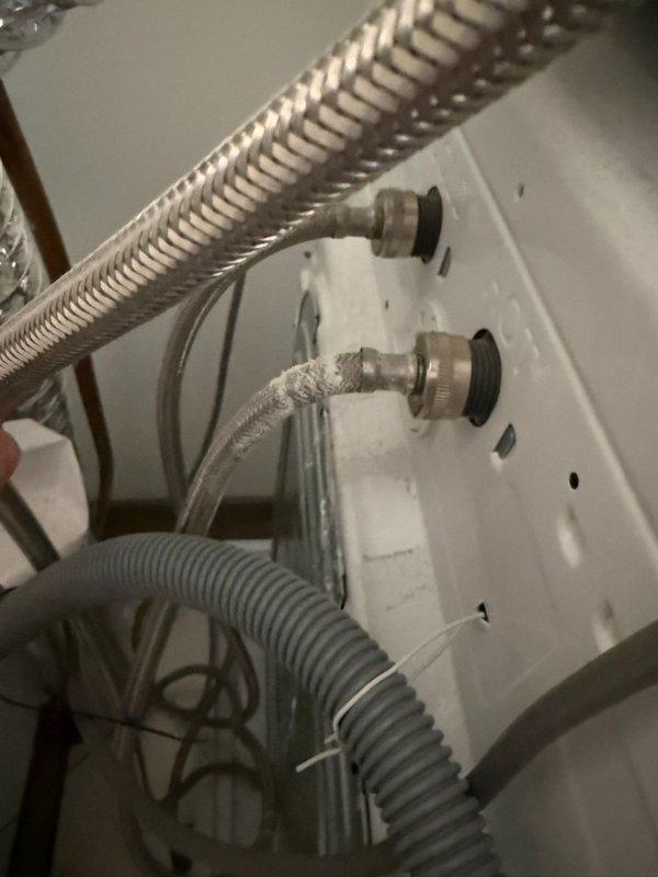 Responded to washing machine water leak caused by failed braided stainless steel supply hose. Shut off water supply valves, removed deteriorated hose showing signs of wear at connection point, and installed new braided supply line with proper gasket seal. Verified all connections were secure, tested for leaks, and confirmed proper water flow to appliance.