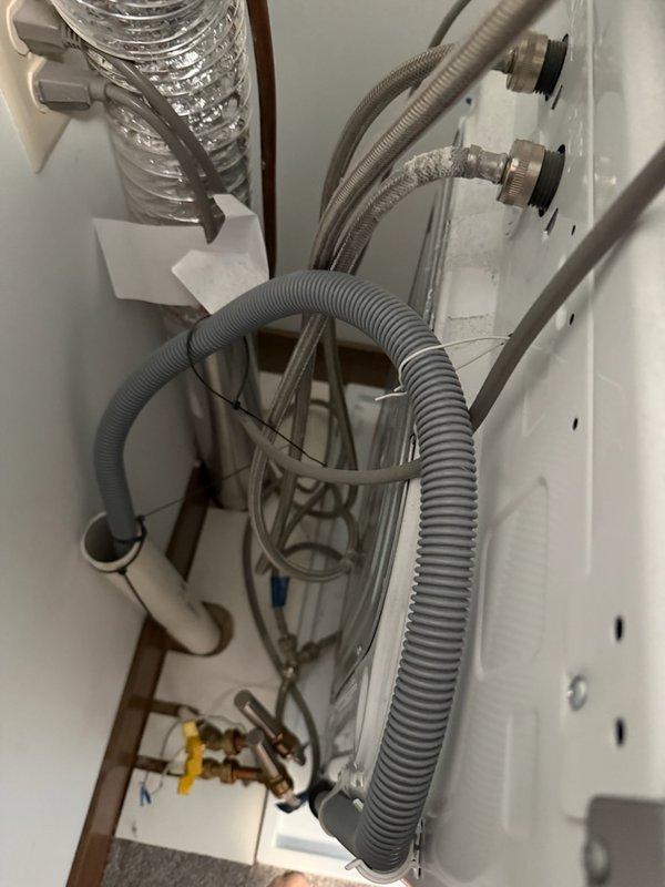 Responded to washing machine water leak caused by failed braided stainless steel supply hose. Shut off water supply valves, removed deteriorated hose showing signs of wear at connection point, and installed new braided supply line with proper gasket seal. Verified all connections were secure, tested for leaks, and confirmed proper water flow to appliance.