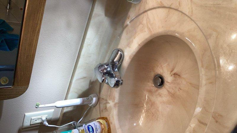 Completed comprehensive plumbing inspection of residential bathroom fixtures. Examined sink assembly, faucet operation, drainage system, and toilet tank components including flapper valve, fill valve assembly, and refill tube for proper functionality and potential issues.