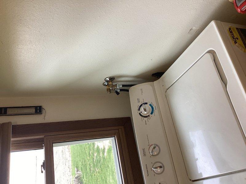 Replaced failing washing machine water supply valve and installed two new washing machine hoses to prevent potential leaking and ensure proper water flow and drainage. Work required accessing closed wall space to complete installation of new valve and secure connections with appropriate hose clamps. All components properly installed and tested for proper operation.
