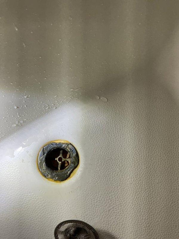 Responded to water leak complaint in shower unit. Upon inspection, identified active leak occurring at back end of shower liner during operation. Traced source to shower valve assembly and discovered pinhole leak in valve body. Documented existing conditions with photographs showing white fiberglass tub/shower combination unit with three-handle chrome fixture configuration and evidence of water infiltration. Provided estimate for shower valve replacement to resolve leak issue.
