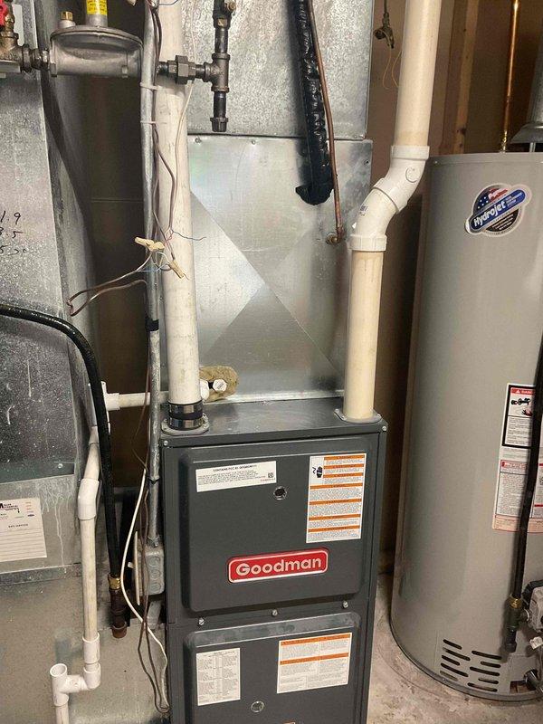 Completed comprehensive AC tune-up on Goodman HVAC system in basement mechanical room. Replaced dirty air filter with new filter and addressed customer concern regarding living room vents with no airflow. Documented equipment make, model, and serial numbers per service protocol.
