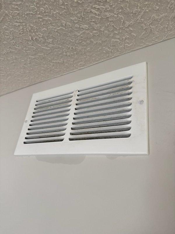Performed comprehensive AC tune-up on 5-year-old Lennox system that had not been serviced in five years. Conducted thorough inspection of all HVAC components including furnace, air handler, and ductwork. Inspected return air vent previously reported to have moisture concerns and rust/warping on vent cover; found no active water intrusion or moisture present at time of service. Deep cleaned outdoor condensing unit, removing accumulated cottonwood debris and dust buildup from coils and components. Verified all electrical connections, blower operation, and accessible system components functioning properly. Due to ambient outdoor temperature of 41°F, refrigerant levels could not be accurately tested or assessed. All accessible ductwork and venting connections inspected and found secure with no visible issues. System operational and performing as expected under current conditions.