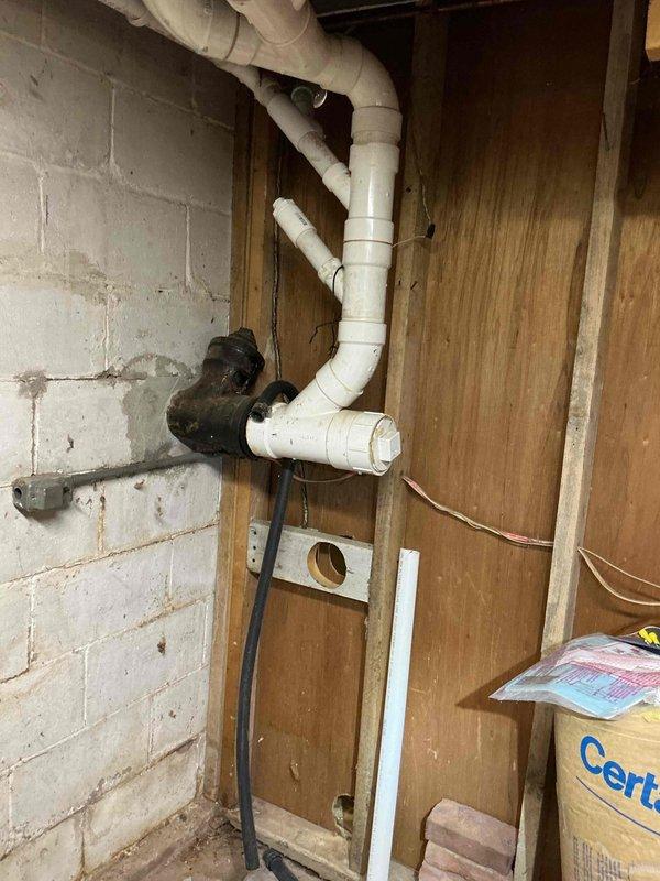 Completed comprehensive plumbing inspection of residential property with no known issues reported prior to visit. Inspected all accessible plumbing systems including water supply lines, drain waste vent piping, and shut-off valves throughout the property. Documented existing conditions with photographic evidence showing PVC drainage system configuration in utility area and water supply valve assembly displaying significant surface corrosion requiring future monitoring.