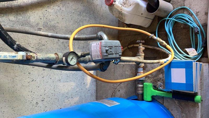 Completed comprehensive plumbing inspection of water heater installation, examining copper supply lines, gas connections, and associated components. Documented existing corrosion on copper piping with visible patina formation, verified proper installation of yellow flexible gas line with appropriate brass fittings and PVC connections, and assessed HVAC refrigeration system equipment including pressure gauges, hoses, and monitoring devices for proper operation and compliance with code requirements.