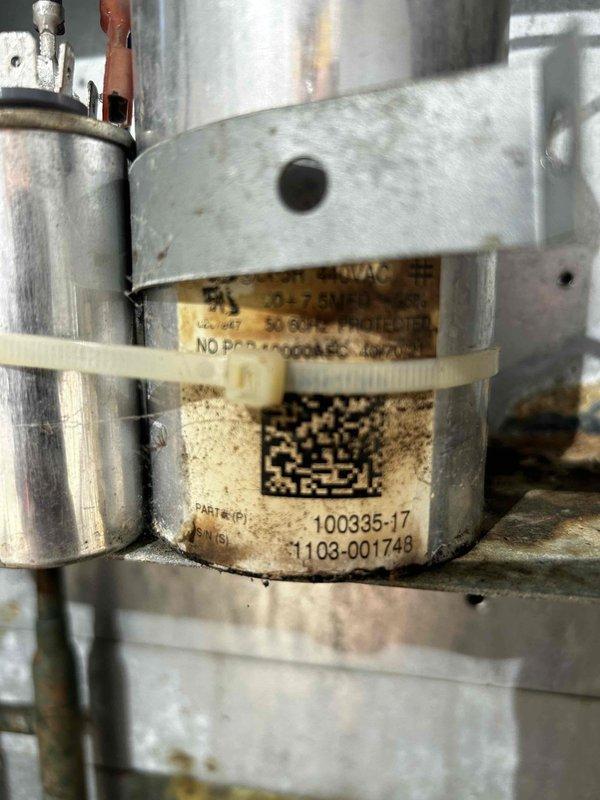 Performed annual AC tune-up on 23-year-old R410A system. Diagnosed no-call condition at thermostat; jumped thermostat to verify AC operation. Inspected indoor unit, flushed condensate drain, and tested blower capacitors—discovered dual 10µF capacitors (totaling 20µF) with one reading 7.5µF and the other near zero. Cleaned outdoor condenser coil and evaluated outdoor capacitors; fan capacitor tested weak, compressor capacitor aged but functional. Verified system pressures and operation. Replaced failed indoor blower capacitors, weak outdoor fan capacitor, and faulty thermostat. Configured new thermostat as heat pump to prioritize hot water fan coil operation before auxiliary electric heat engages. Tested and confirmed proper heating and cooling operation upon completion.