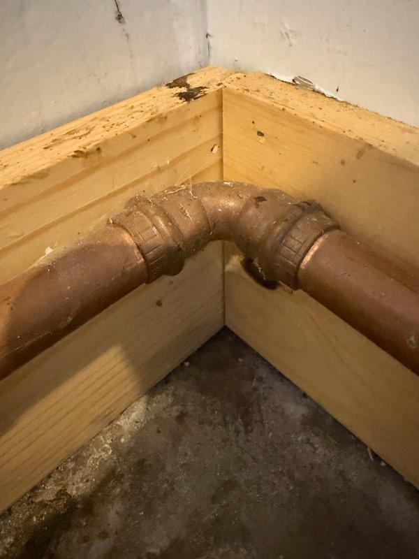 Responded to emergency call for burst copper pipe in garage. Upon inspection, identified frozen and split copper line approximately one inch in diameter serving exterior spigot, with damage extending to boiler drain connection. Removed approximately three feet of compromised copper piping showing severe frost damage and corrosion. Installed new copper pipe section with proper fittings and joints, ensuring secure connections at both termination points. Tested system for leaks and verified proper water flow to exterior spigot and boiler drain. All connections soldered and pressure-tested to code specifications.