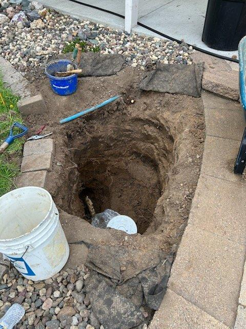 # Water Line Repair - Poly Line Split

Responded to a water leak in an underground poly water line. Upon excavation near the building foundation, located a split in the polyethylene supply line causing active water loss. Dug approximately 3-4 feet deep to expose the damaged section of pipe and assess the extent of the failure. The deteriorated condition of the line indicated prolonged exposure to soil conditions and possible stress fractures.

Documented the damage through photographs showing the excavation site, exposed piping, and surrounding work area. Discussed repair options and provided estimates for permanent line replacement. Ordered necessary parts including replacement poly line sections and fittings to complete the repair. Secured the excavation site with appropriate safety measures and prepared the area for follow-up installation work once materials arrive.

The repair will involve removing the damaged section of poly line and installing new piping with proper connections t