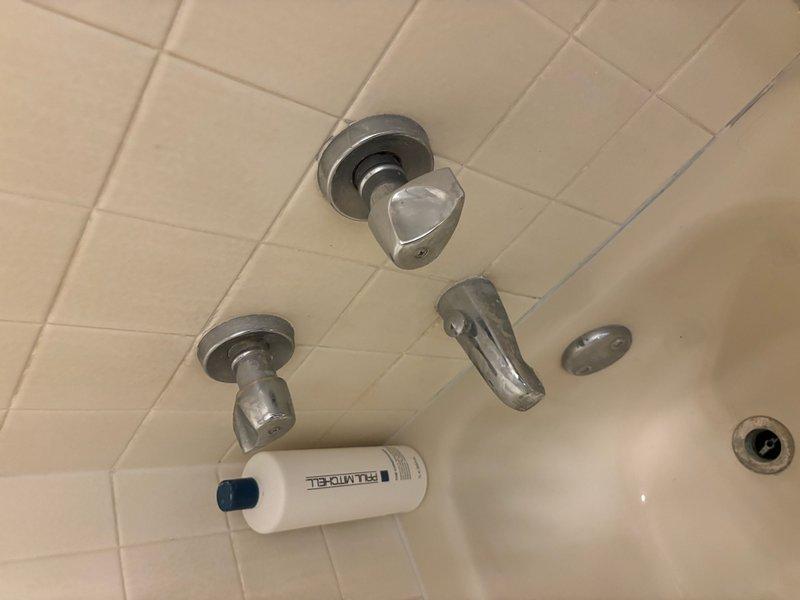 Responded to a callback for a hallway bathroom toilet that was periodically running and leaking. Upon inspection, discovered the flapper had become dislodged from the flush valve hinge. Reinstalled the flapper and properly secured it to the flush valve assembly to restore proper operation. Additionally, documented existing bathroom fixtures with photographs for future estimate preparation, including hallway bathroom fixtures and primary shower trim replacement.