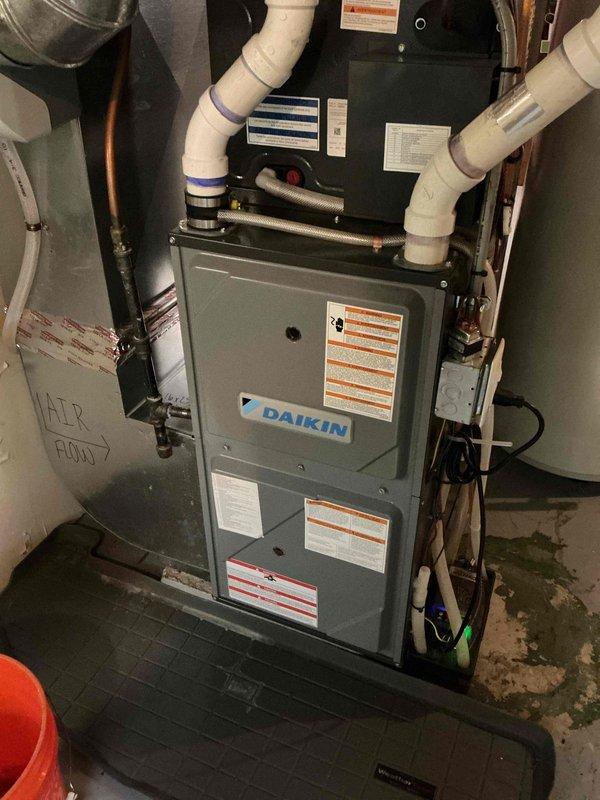 Completed preventive maintenance tune-up on a 6-year-old Daikin side discharge air conditioning system under manufacturer warranty as part of plan agreement. Performed visual inspection of all components, verified temperature split across evaporator coil indicating proper refrigerant charge, and cleaned outdoor condenser coil to ensure optimal heat transfer. Due to equipment design specifications, refrigerant pressures were not measured; all other system components including blower operation, electrical connections, and safety controls tested within manufacturer specifications and system confirmed fully operational.