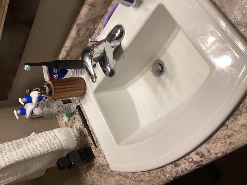 Completed comprehensive plumbing inspection on seven-year-old residential property. All plumbing fixtures, including bathroom sinks and faucets, were visually inspected and found to be in proper working condition with no leaks or defects noted. Verified water pressure regulator is functioning correctly with system pressure reading between 5-7 PSI, which is within acceptable parameters for residential applications.