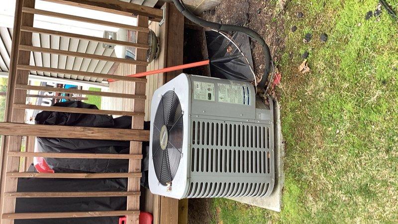Performed scheduled maintenance tune-up on 10-year-old R-22 air conditioning system. Upon inspection, discovered inadequate cooling performance with only 14-degree temperature drop across the system. Diagnostic testing revealed low suction pressure of approximately 50 PSI, indicating the unit is approximately one pound low on refrigerant. Observed evaporator coil beginning to freeze due to low refrigerant charge. Completed standard tune-up procedures including system inspection and performance testing. Unit requires refrigerant recharge; however, customer was previously provided estimate regarding R-22 refrigerant availability and has requested to consult with advisor before proceeding with repairs.