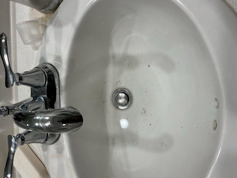 Responded to a bathroom sink drain obstruction. Upon arrival, found the pop-up assembly completely clogged and preventing drainage. Removed the existing pop-up assembly and installed a grid strainer style drain as a replacement to address recurring drainage issues. Performed three full-basin water tests to verify proper drainage and flow rate. Conducted thorough leak inspection of all connections with no leaks detected. System restored to full functionality.