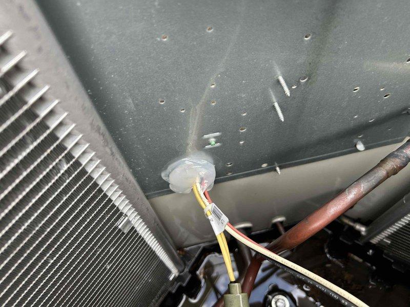 Completed annual air conditioning tuneup on Frigidaire condenser unit. Discovered deceased mouse on capacitor during inspection. Thoroughly inspected all electrical wiring and components, which tested within normal operating parameters despite the rodent intrusion. Sealed entry point with silicone to prevent future pest access. Removed top panel and rinsed evaporator coil to ensure optimal heat transfer. Cleared condensate drain line using compressed air. Verified air filter had been recently replaced. Measured temperature split at 18°F, confirming proper refrigerant charge and system performance. All components functioning correctly with no issues identified at time of service completion.