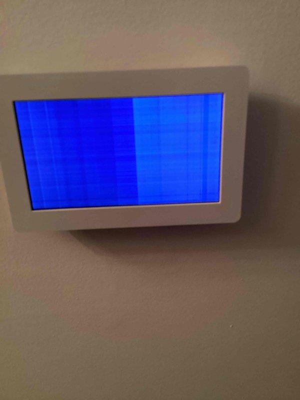Responded to service call for malfunctioning Lennox thermostat with inoperable display screen showing scrambled blue vertical bands. Diagnosed faulty thermostat unit and successfully replaced with new unit, restoring proper HVAC system control and functionality.