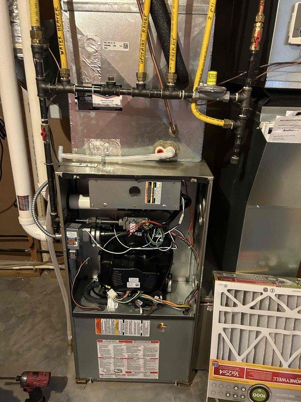 Replaced variable speed combustion inducer assembly on residential furnace. The new inducer was an updated version that created a clearance issue with the pressure switch under the ECM housing. Removed and repositioned mounting brackets and insulated exposed terminals to achieve proper fit. Verified furnace ignition sequence and operation upon completion.