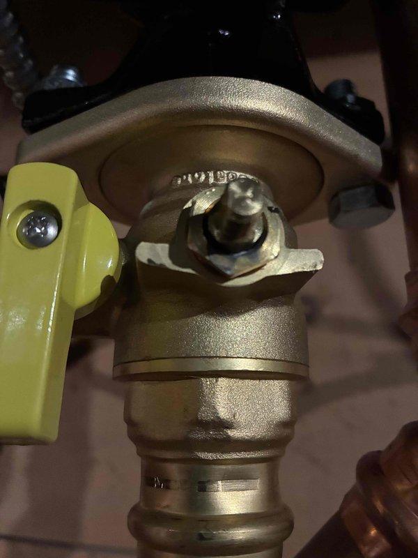 Responded to boiler leak warranty call. Upon inspection, identified loose packing on ball valve as source of water leakage at packing nut. Tightened packing nut approximately 1/4 turn to secure seal. Performed preventive maintenance by inspecting and snugging down packing on all ball valves throughout system. Leak successfully resolved with no parts replacement required. System tested and verified operational with no further water discharge.