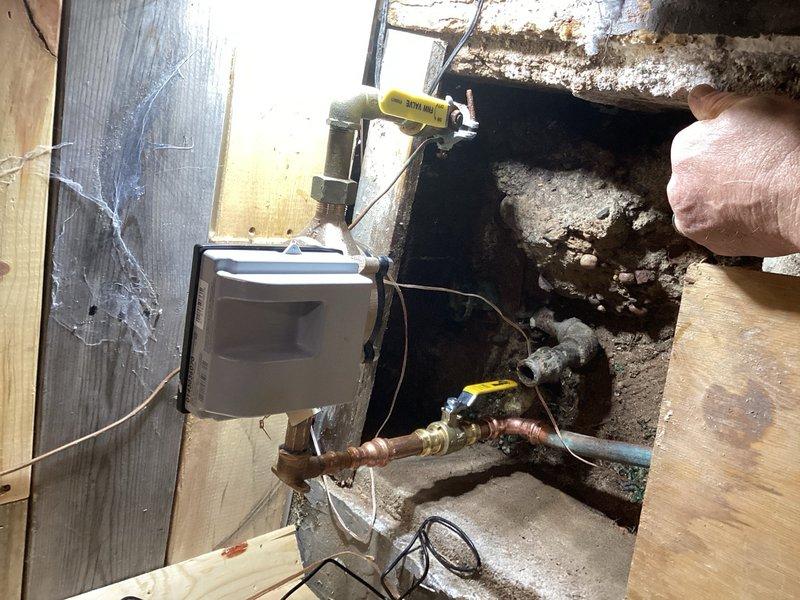 Responded to service call for water meter replacement coordination with municipal water authority. The existing shut-off valve before the meter required replacement to allow the city to install new meter. Coordinated water shut-off scheduling with municipality. Removed existing shark bite fittings on both sides of the water meter. Cut out two shark bite fittings and installed a new three-quarter inch ball valve on the house side of the meter. Replaced outdated shark bite connections with proper fittings to meet code requirements and ensure reliable long-term performance. Work completed in crawl space utility area with corroded existing copper piping. All connections tested and verified operational upon water service restoration.