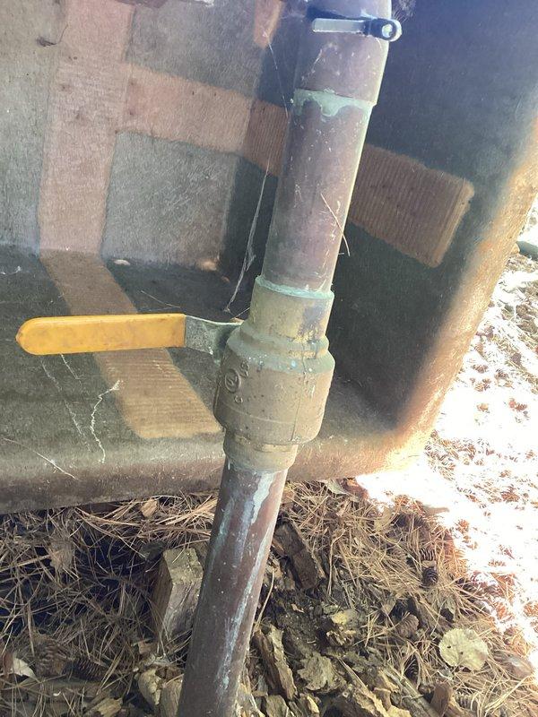 Responded to irrigation system water leak located before the meter, with municipal water supply shut off by city. Upon inspection, identified a split ball valve on the copper supply line as the source of the leak. Documented the failed valve assembly and surrounding plumbing configuration with photographs showing visible corrosion and age-related deterioration on copper piping. Provided estimate for ball valve replacement and necessary repairs to restore irrigation system functionality for HOA property.