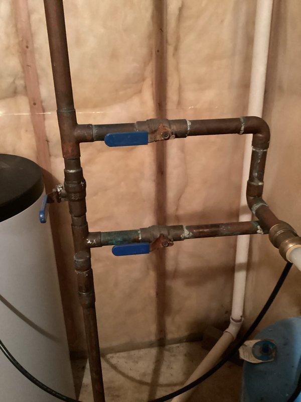 Completed comprehensive plumbing inspection of residential water heating system. Inspected 40-gallon natural gas water heater manufactured by Reliance Water Heater Co. (Model 9211614005, Serial 1117A081579, installed April 2011) and associated copper and PEX piping distribution system with dual ball valve isolation points. All components examined and photographed; system found to be in functional operating condition with age-appropriate wear patterns on copper piping and tank surfaces.
