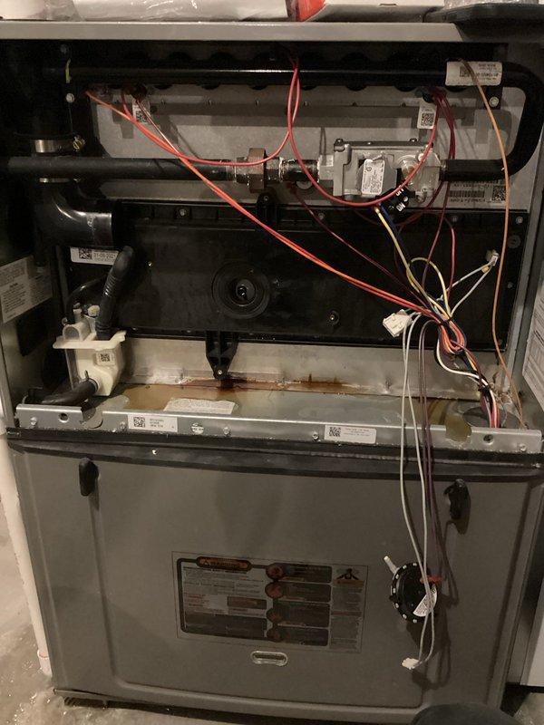 Responded to callback for water leakage around furnace area following recent HVAC tune-up. Upon inspection, determined leak was not originating from humidifier but from compromised collector box at bottom of unit. Removed and replaced failed collector box with new unit. Inspected original collector box and confirmed structural compromise causing water discharge. Tested system operation after replacement to verify proper drainage and no further leakage present.