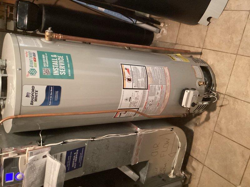 Responded to service call for a 3-year-old Bradford White 40-gallon natural gas water heater displaying a solid red indicator light and not producing hot water. Upon arrival, found the unit in the off position with the pilot light extinguished. Relit the pilot light and turned the gas valve to the on position to engage the main burner. The burner ignited properly and maintained steady flame during observation. Exercised the gas valve by cycling between pilot mode and temperature settings to verify proper operation and response. Contacted Bradford White technical support to confirm diagnostic interpretation of the solid red light error code, which indicated no flame detection by the gas valve sensor. Per manufacturer recommendation, performed a gas valve reset procedure to clear any potential fault conditions. Following the reset, conducted multiple operational tests to confirm the gas valve was functioning correctly and the burner was cycling on and off as designed. Verified proper fla