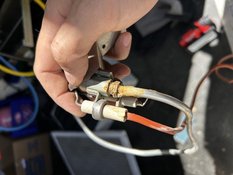 Responded to no heat call on 1994 Lennox propane furnace. Upon arrival, found pilot would ignite but main burner would not light, with igniter sparking continuously for approximately 30 seconds before system shutdown. Removed pilot assembly and thoroughly cleaned spark rod, flame sensor, and verified pilot tube was clear of obstructions. Reinstalled pilot assembly and tested system operation—unit now igniting properly and heating as designed. Performed visual inspection of heat exchanger with no condemnable cracks observed.