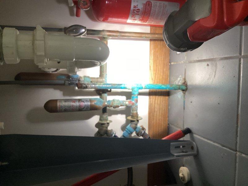 Responded to emergency plumbing call for burst pipe in residential property. Upon arrival, water supply to home had been shut off due to active leak. Investigation revealed that city fire hydrant purging had caused pressure surge, resulting in failure of compression nut on laundry tub hot water supply line. The compromised compression fitting caused pipe to burst and spray water throughout the area. Removed failed compression shutoff valve and damaged compression nut from hot supply line. Installed new compression shutoff valve with proper fittings to restore water supply control to laundry tub. Tested new installation for leaks and proper operation. Water supply to home restored and system verified functional.