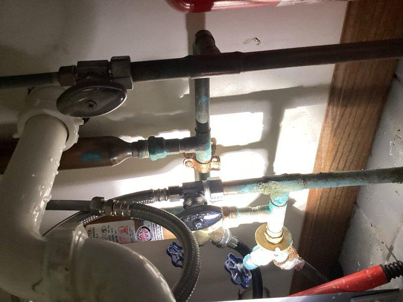 Responded to emergency plumbing call for burst pipe in residential property. Upon arrival, water supply to home had been shut off due to active leak. Investigation revealed that city fire hydrant purging had caused pressure surge, resulting in failure of compression nut on laundry tub hot water supply line. The compromised compression fitting caused pipe to burst and spray water throughout the area. Removed failed compression shutoff valve and damaged compression nut from hot supply line. Installed new compression shutoff valve with proper fittings to restore water supply control to laundry tub. Tested new installation for leaks and proper operation. Water supply to home restored and system verified functional.