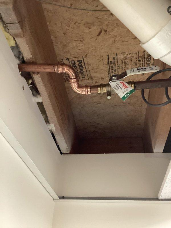 Responded to callback for leaking irrigation ball valve installed 4-5 months prior. Upon inspection, identified leak at first 90-degree elbow fitting immediately after the valve assembly. Since installation was within the one-year warranty period, accessed the through-wall piping system via ceiling cavity and replaced the defective 90-degree copper fitting and associated connections. Resoldered joints to ensure watertight seal and verified system integrity upon completion.