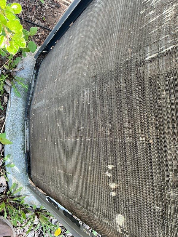 Completed annual air conditioning maintenance tune-up on a 5-year-old system. Rinsed condenser coil to remove accumulated dirt and debris, inspected pleated air filters showing dust accumulation, and documented system condition with photos. Customer orders replacement filters online for ongoing maintenance.