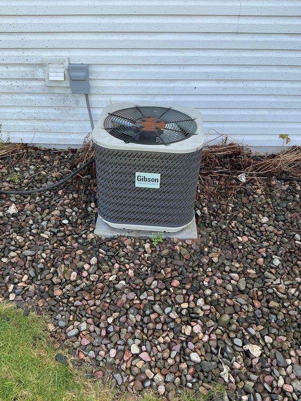 Completed comprehensive 12-month preventative maintenance on Gibson HVAC system, original to home since 2004. Performed outdoor condenser unit cleaning, removed debris and vegetation from around unit, flushed evaporator coil and condensate drain line inside furnace closet. Tested all electrical components, verified proper amperage draws, and confirmed operational functionality of heating and cooling systems. Documented equipment model and serial numbers with photographs for service records.