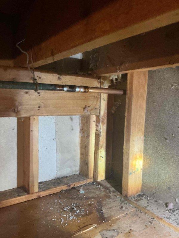 Responded to service call for inoperable outdoor spigot at rear of property. Upon inspection, determined that the existing hose bib had failed and required complete replacement. Accessed the water supply line through crawlspace, which required working in confined space with exposed floor joists and existing plumbing infrastructure. Shut off water supply to the affected fixture and removed the damaged spigot assembly. Installed new frost-free hose bib with proper mounting and secure connections to the existing copper supply line. Verified all connections were leak-free and restored water supply. Tested the new outdoor faucet for proper operation and flow. Installation completed successfully with fixture now fully operational.