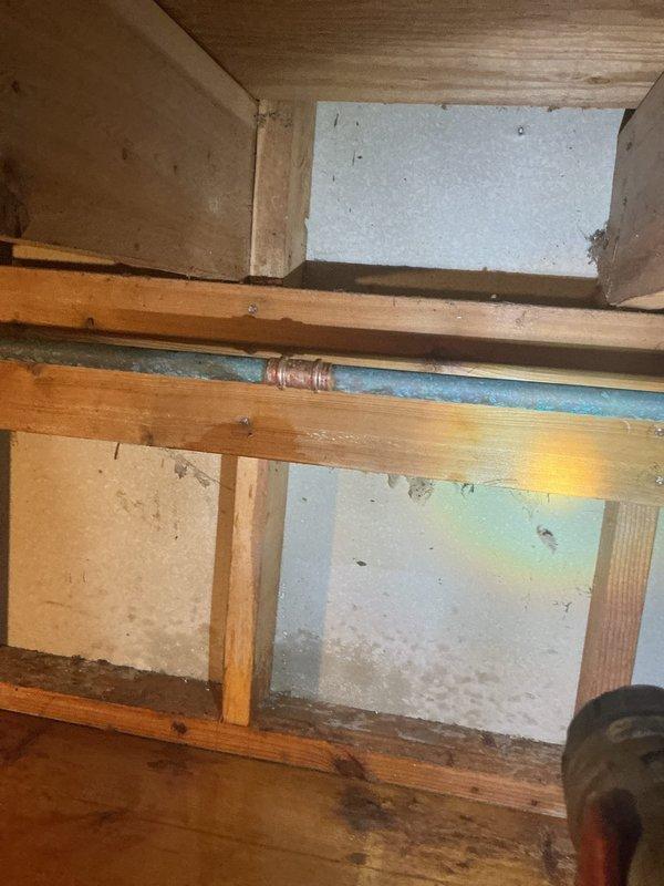 Responded to service call for inoperable outdoor spigot at rear of property. Upon inspection, determined that the existing hose bib had failed and required complete replacement. Accessed the water supply line through crawlspace, which required working in confined space with exposed floor joists and existing plumbing infrastructure. Shut off water supply to the affected fixture and removed the damaged spigot assembly. Installed new frost-free hose bib with proper mounting and secure connections to the existing copper supply line. Verified all connections were leak-free and restored water supply. Tested the new outdoor faucet for proper operation and flow. Installation completed successfully with fixture now fully operational.